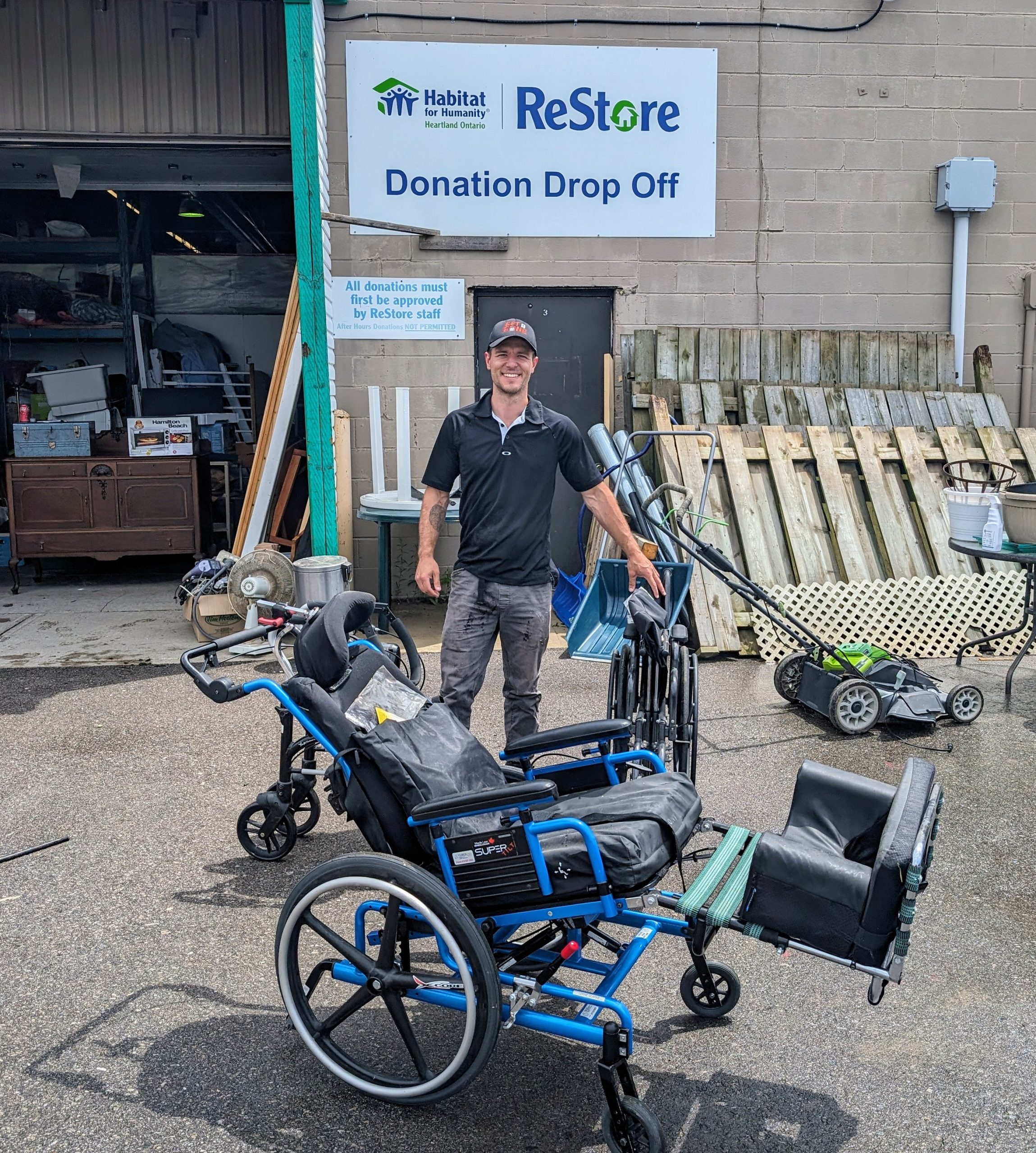 Mike Metcalfe from Get R Gone junk removal donating a wheelchair to the Habitat for Humanity Restore in St. Thomas