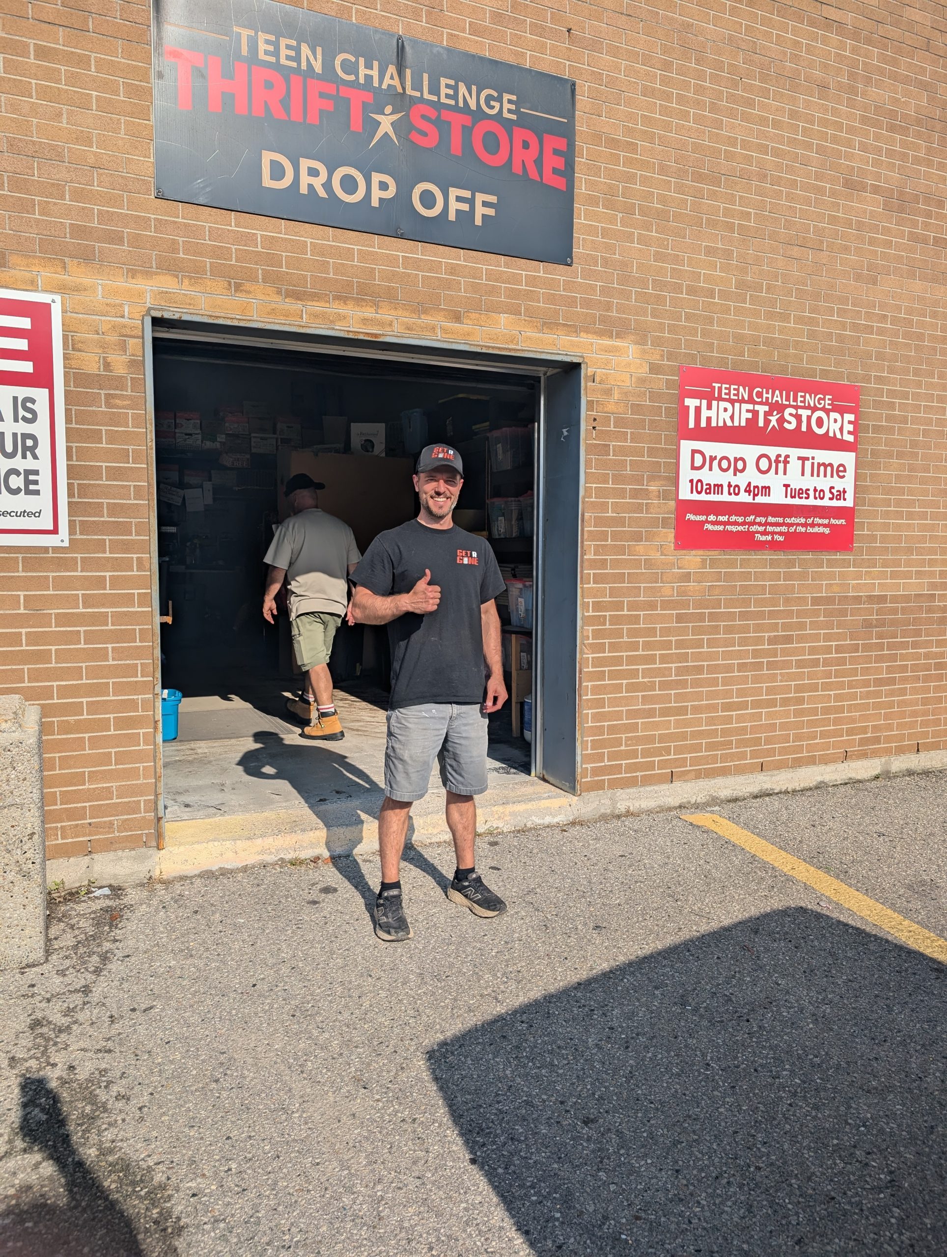 Mike Metcalfe from Get R Gone Junk Removal Posing in front a Teen Challenge in London Ontario